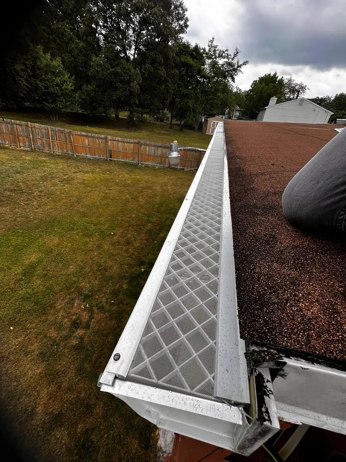Gutter guard installation on a residential roofline